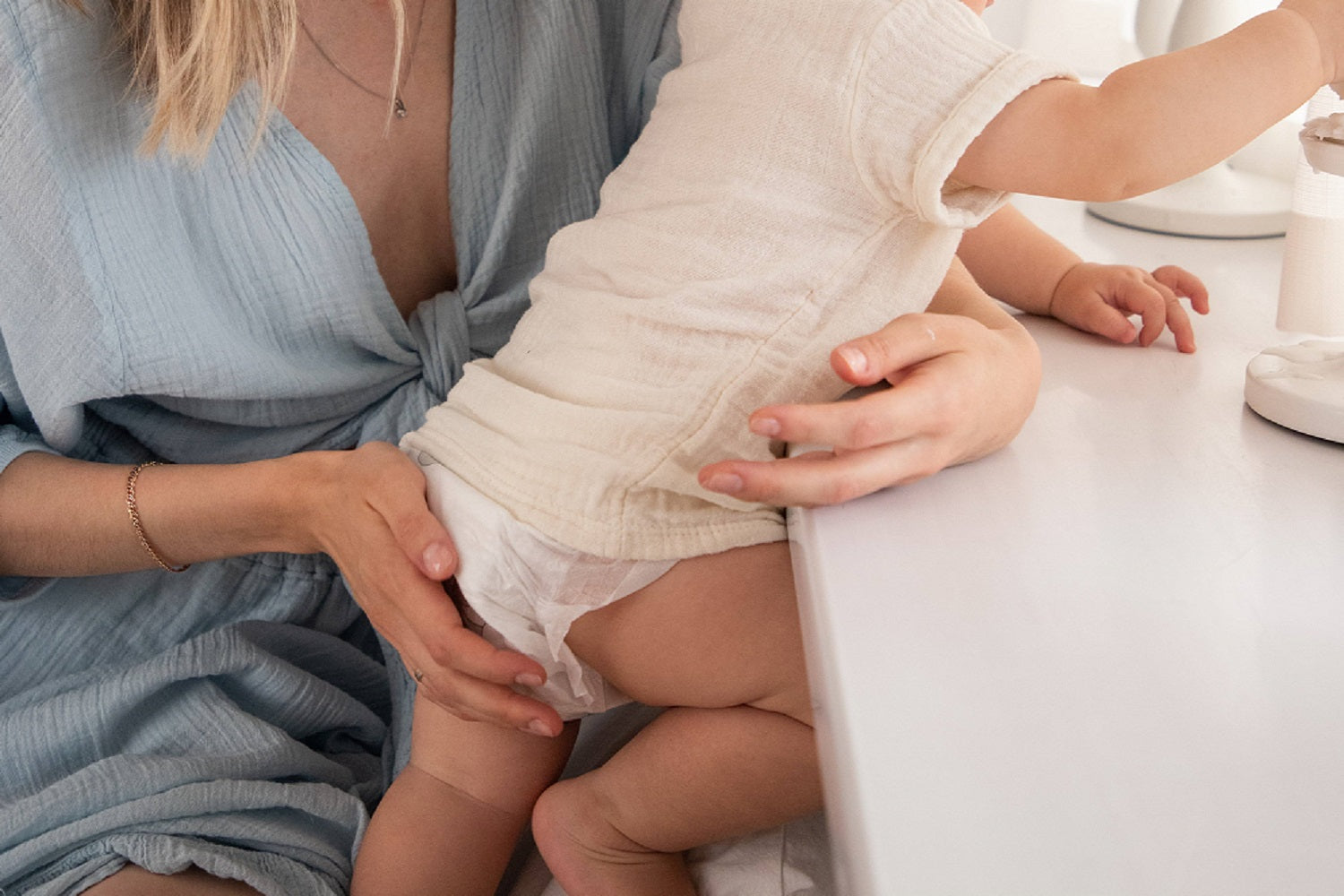 A baby who has just learned to crawl, wearing an aiwibi  diaper